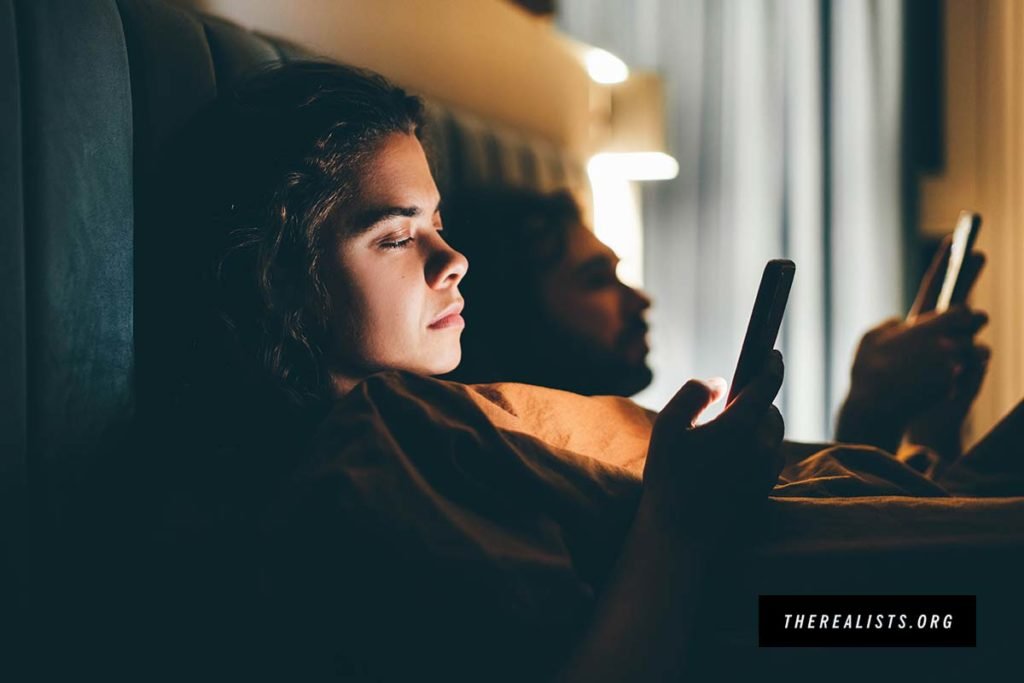 The Realists communication advertising couple bed smartphones