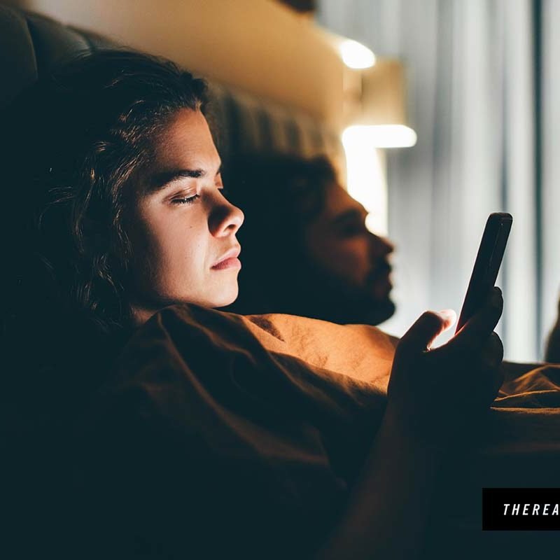 The Realists communication advertising couple bed smartphones