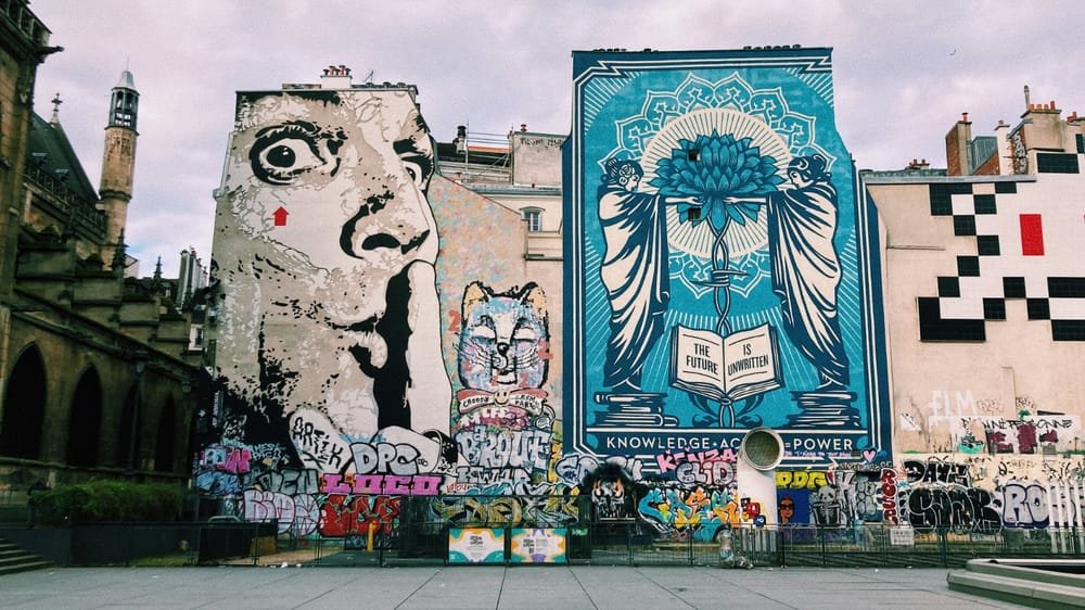 Murals in Paris: right, Shepard Farey's "The Future is Unwritten"